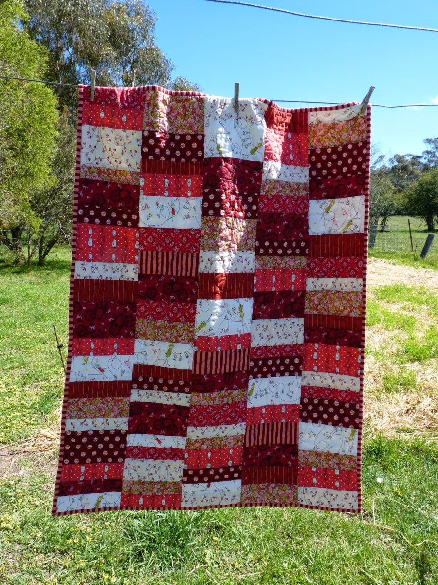 Red and white strip quilt